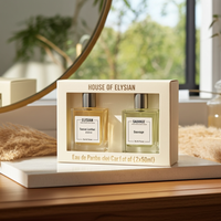 House of Elysian perfume set with two bottles in a box on a wooden surface.
