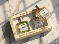Two Elysian perfume bottles with their packaging on a marble surface