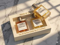 Two Elysian perfume bottles in a box on a marble surface